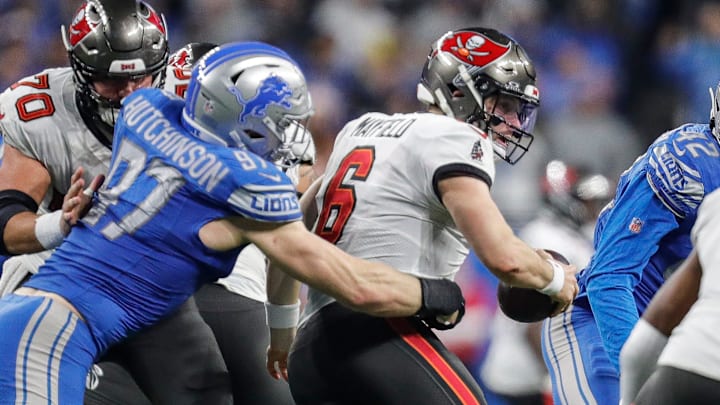 Detroit Lions defensive end Aidan Hutchinson (97) tackles Tampa Bay Buccaneers quarterback Baker Mayfield (6) during the second half of the NFC divisional round at Ford Field in Detroit on Sunday, Jan. 21, 2024.