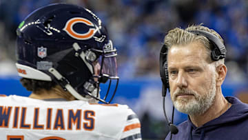 Chicago Bears head coach Matt Eberflus talks to quarterback Caleb Williams (on the sidelines.