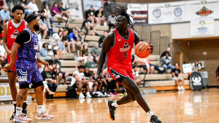 Michigan State freshman and Team Goodfellas' Kur Teng, moves the ball against Team Case Credit Union in the game on Tuesday, June 25, 2024, during the Moneyball Pro-Am at Holt High School.