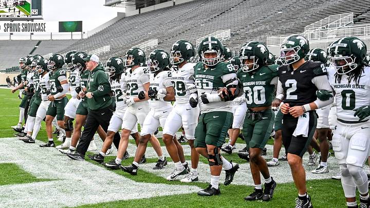 Michigan State's head coach Pat Fitzgerald and the team walk across the end zone during the football Spring Showcase on Saturday, April 18, 2026, at Spartan Stadium in East Lansing.