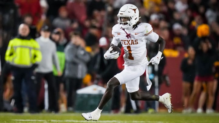 Nov 18, 2023; Ames, Iowa, USA; Texas Longhorns wide receiver Xavier Worthy (1) carries the ball in the first half of the Longhorns' game against the Iowa State Cyclones at Jack Trice Stadium. Mandatory Credit: Sara Diggins-USA TODAY Sports