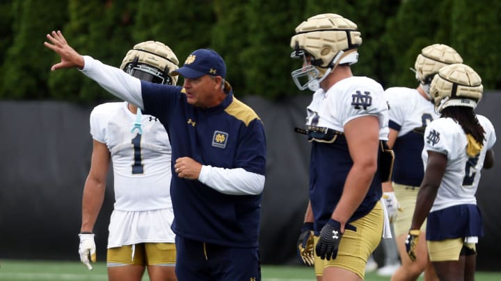 Notre Dame offensive coordinator Mike Denbrock gives instructions to senior tight end Kevin Bauman during a practice Friday, August 2, 2024, at the Irish Athletics Center in South Bend.