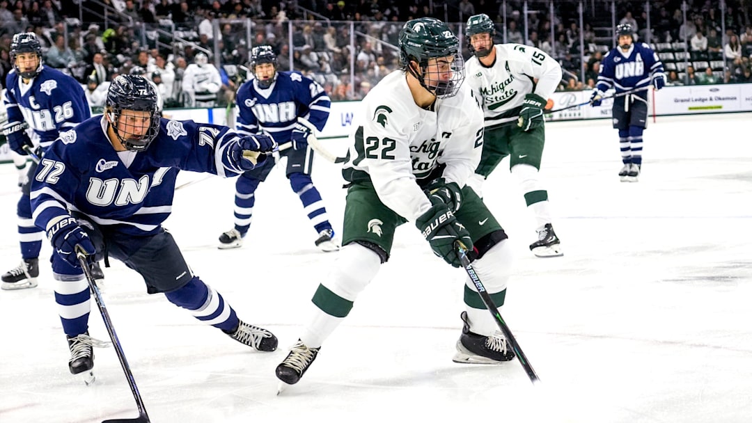 Michigan State's Porter Martone, right, moves the puck as New Hampshire's Conner de Haro closes in during the first period on Thursday, Oct. 9, 2025, at Munn Ice Arena in East Lansing. Michigan State's Porter Martone, right, moves the puck as New Hampshire's Conner de Haro closes in during the first period on Thursday, Oct. 9, 2025, at Munn Ice Arena in East Lansing.