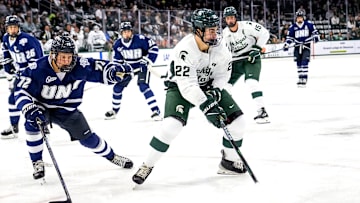 Michigan State's Porter Martone, right, moves the puck as New Hampshire's Conner de Haro closes in during the first period on Thursday, Oct. 9, 2025, at Munn Ice Arena in East Lansing.