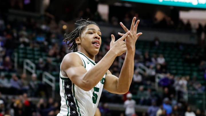 Cass Tech guard Darius Acuff (5) celebrates a play against Muskegon during the second half of the MHSAA boys Division 1 final at Breslin Center in East Lansing on Saturday, March 25, 2023.