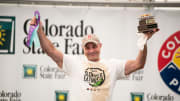 Geoffrey Esper raises his ribbon and trophy after taking the title at the 2021 World Slopper Eating Championship during the Colorado State Fair in Pueblo on Saturday September 4, 2021.

Slopper Contest Geoff Esper Trophy