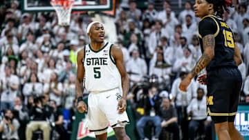 Michigan State's Tre Holloman, left, jaws at Michigan's Rubin Jones after scoring during the second half on Sunday, March 9, 2025, at the Breslin Center in East Lansing.