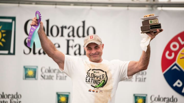 Geoffrey Esper raises his ribbon and trophy after taking the title at the 2021 World Slopper Eating Championship during the Colorado State Fair in Pueblo on Saturday September 4, 2021.

Slopper Contest Geoff Esper Trophy