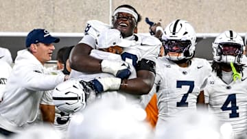 Penn State Nittany Lions offensive lineman Anthony Donkoh hugs interim head coach Terry Smith after a win over Michigan State.