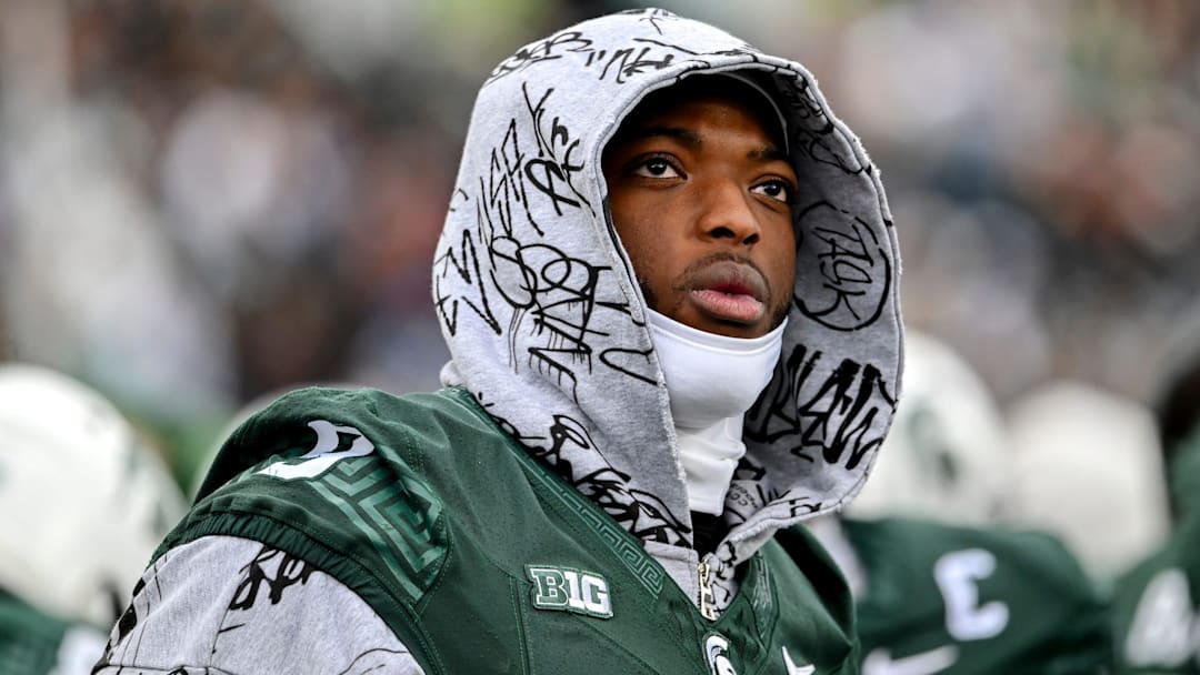 Michigan State's Jalen Thompson dressed in street clothes looks on from the sideline during the first quarter in the game against UCLA on Saturday, Oct. 11, 2025, at Spartan Stadium in East Lansing. Michigan State's Jalen Thompson dressed in street clothes looks on from the sideline during the first quarter in the game against UCLA on Saturday, Oct. 11, 2025, at Spartan Stadium in East Lansing.