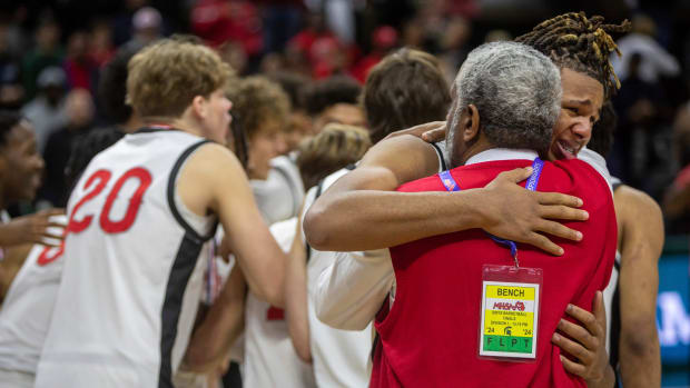 Orchard Lake St. Mary's Trey McKenney hugs his coach after defeating North Farmington 63-52 during the Div. 1 state finals