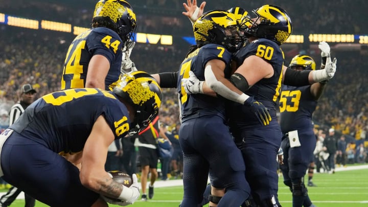 Michigan running back Donovan Edwards celebrates with Michigan offensive lineman Drake Nugent after a touchdown in the first quarter during the College Football Playoff national championship game against Washington at NRG Stadium in Houston on Monday, Jan. 8, 2024.