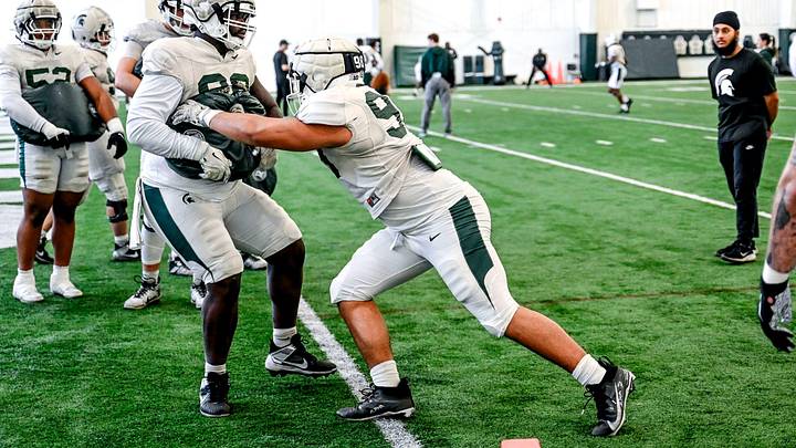 Michigan State's Derrick Simmons, right, and Quindarius Dunnigan work out with the defensive line during football practice on Tuesday, April 8, 2025, in East Lansing.