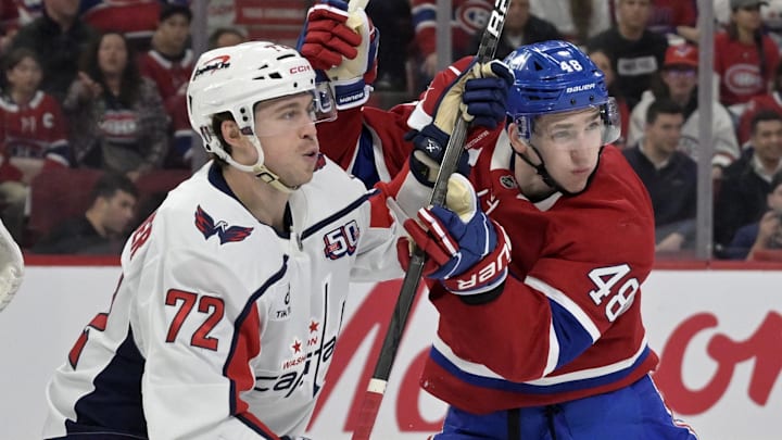 Apr 25, 2025; Montreal, Quebec, CAN; Washington Capitals forward Anthony Beauvillier (72) and Montreal Canadiens defenseman Lane Hutson (48) battle in front of the net during the first period in game three of the first round of the 2025 Stanley Cup Playoffs at the Bell Centre. Mandatory Credit: Eric Bolte-Imagn Images