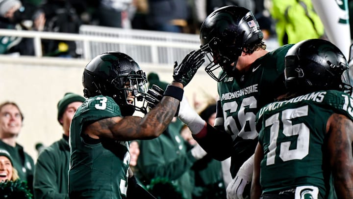 Michigan State's Montorie Foster Jr., left, celebrates his touchdown with teammate Ashton Lepo during the first quarter in the game against Purdue on Friday, Nov. 22, 2024, at Spartan Stadium in East Lansing.