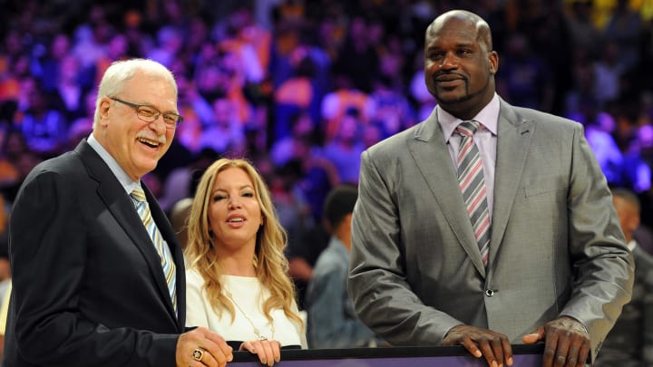 Apr 2, 2013; Los Angeles, CA, USA;   Phil Jackson (left) and Jeannie Buss stand with Los Angeles Lakers former player Shaquille O'Neal as his jersey is retired during a half time ceremony during the game against the Dallas Mavericks at the Staples Center. Mandatory Credit: Jayne Kamin-Oncea-USA TODAY Sports