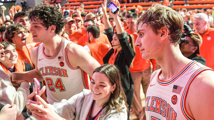 Jan 14, 2023; Clemson, South Carolina, USA; Clemson sophomore forward PJ Hall (24) and Clemson forward Hunter Tyson (5) celebrate with fans after the Tigers beat Duke 72-64 at Littlejohn Coliseum.