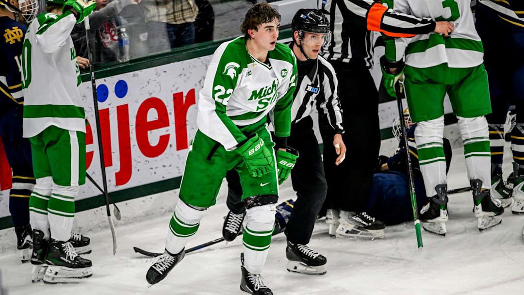 Michigan State's Porter Martone is escorted away from the scuffle during the second period in the game against Notre Dame on Thursday, Feb. 19, 2026, at the Munn Ice Arena in East Lansing.