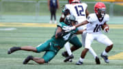 Cass Tech defender Cashus Shivers tries to tackle Southfield A&T defensive back Paydon Jones during first half action Saturday, August 26, 2023.