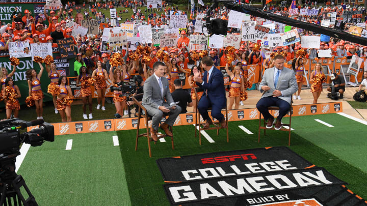 Oct 1, 2022; Clemson, South Carolina, USA; Clemson head coach Dabo Swinney (middle) claps and interacts with the fans while seated between analysts Rece Davis and Kirk Herbstreit during ESPN College GameDay before playing the NC State Wolfpack at Memorial Stadium. 