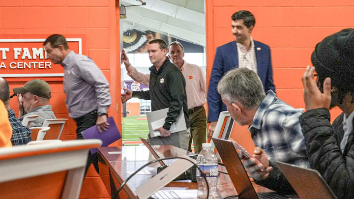 Chad Morris, middle, arrives with Head Coach Dabo Swinney, left, and Athletic Director Graham Neff, right, before being introduced as Clemson football Offensive Coordinator for coach Dabo Swinney, during a press conference in the Smart Family Media Center in Clemson, SC, Friday, Jan 23 2026.