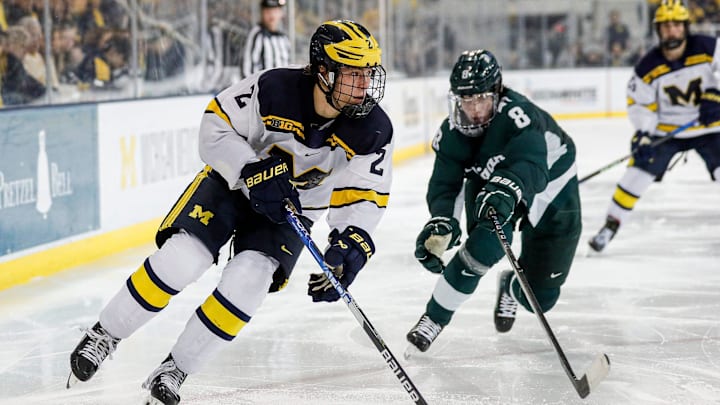 Michigan left wing Rutger McGroarty looks to pass against Michigan State defenseman Maxim Strbak during the third period at Yost Ice Arena in Ann Arbor on Friday, Feb. 9, 2024.