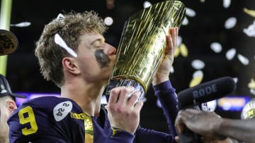 Michigan quarterback J.J. McCarthy misses the trophy to celebrate 34-13 win over Washington at the national championship game at NRG Stadium in Houston on Monday, Jan. 8, 2024.