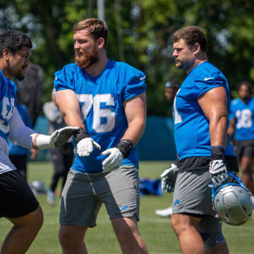 Detroit Lions offensive lineman Penei Sewell (58) practices football maneuvers with Connor Galvin (76) 