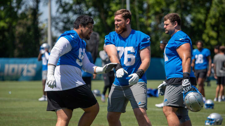 Detroit Lions offensive lineman Penei Sewell (58) practices football maneuvers with Connor Galvin (76) 