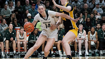 Michigan State's Grace VanSlooten (14) drives along the baseline past Iowa's Addison Grady (44) Sunday, Dec. 15, 2024 at the Breslin Center.