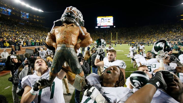 Michigan State offensive linemen Nick Padla, left, and Donavon Clark, right, hold the Paul Bunyan trophy, which has a Spartan helmet on, as they sing the fight song after MSU's 27-23 win over Michigan on Oct. 17, 2015, in Ann Arbor.

Paul Bunyan trophy