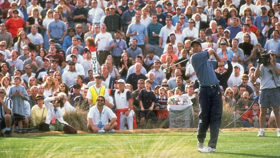 Tiger Woods watches the hole-bound shot at TPC Scottsdale's famed 16th hole in 1997. 