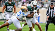 Michigan State's Jack Velling, right, runs after a catch as UCLA's Anthony Jones attempts the tackle during the first quarter on Saturday, Oct. 11, 2025, at Spartan Stadium in East Lansing.
