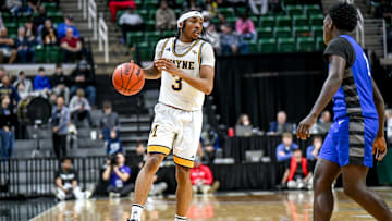 Wayne Memorial's Carlos Medlock Jr. moves the ball against Flint Carman-Ainsworth during the second quarter in the Division 1 state semifinal on Friday, March 14, 2025, at the Breslin Center in East Lansing.