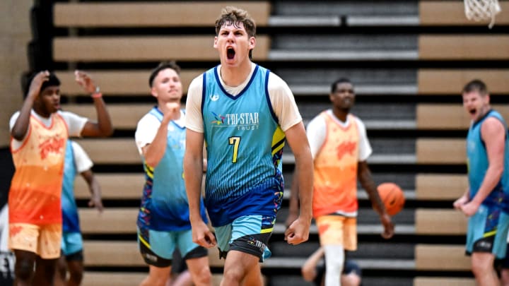 Team Tri-Star Trust and Michigan State's Gehrig Normand celebrates after making a 3-pointer and drawing a foul against Team Faygo in the game on Tuesday, July 9, 2024, during the Moneyball Pro-Am at Holt High School.