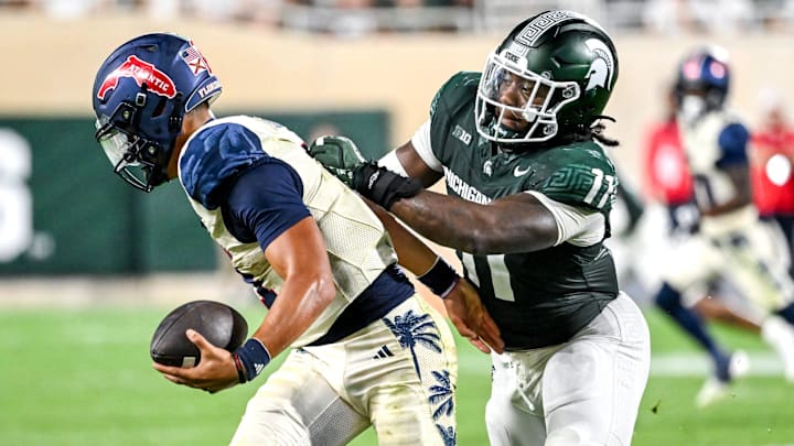 Michigan State's Ken Talley, right, tackles Florida Atlantic's Cam Fancher for a loss on fourth down during the fourth quarter on Friday, Aug. 30, 2024, at Spartan Stadium in East Lansing.