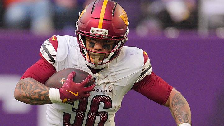 Dec 7, 2025; Minneapolis, Minnesota, USA; Washington Commanders running back Chris Rodriguez Jr. (36) rushes the ball against the Minnesota Vikings during the second half at U.S. Bank Stadium. 