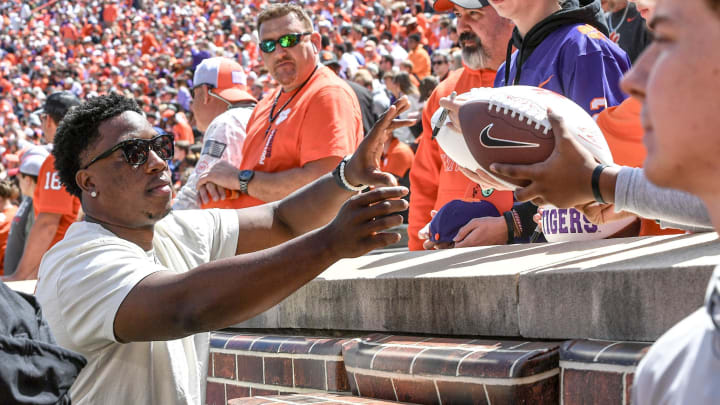 Former player K.J. Henry signs autographs before the Spring football game in Clemson, S.C. Saturday, April 6, 2024.