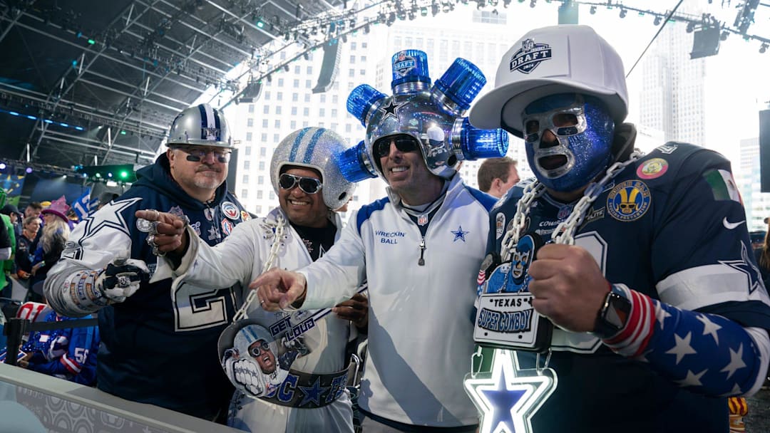 Dallas Cowboys fans pose in the main theater for the first day of the NFL Draft in Detroit. Dallas Cowboys fans pose in the main theater for the first day of the NFL Draft in Detroit.