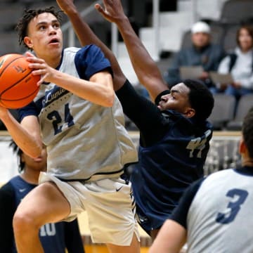 La Lumiere junior Darius Adams looks to put up a shot around teammate Jonas Muya during an open practice Thursday, Nov. 9, 2023, at the La Porte Civic Auditorium.