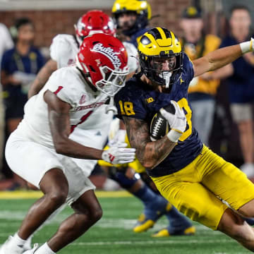 Michigan tight end Colston Loveland (18) makes a catch for a first down against Fresno State defensive back Cam Lockridge (1) during the second half at Michigan Stadium in Ann Arbor on Saturday, Aug. 31, 2024.