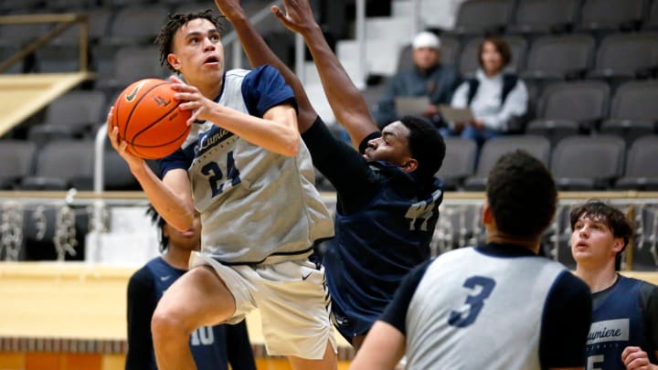 La Lumiere junior Darius Adams looks to put up a shot around teammate Jonas Muya during an open practice Thursday, Nov. 9, 2023, at the La Porte Civic Auditorium.