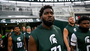 Michigan State's Kristian Phillips and the Spartans take the field for warm ups before the game against Florida Atlantic on Friday, Aug. 30, 2024, at Spartan Stadium in East Lansing.