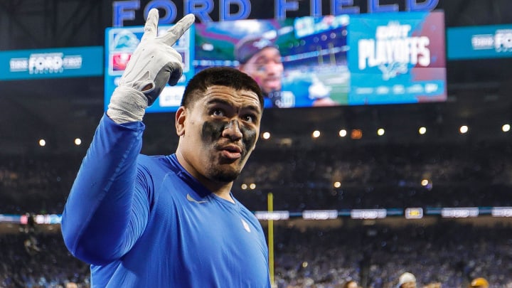 Detroit Lions offensive tackle Penei Sewell signals for two more wins as he celebrates the 31-23 victory over the Tampa Bay Buccaneers in the NFC divisional round playoff game at Ford Field in Detroit on Sunday, Jan. 21, 2024.