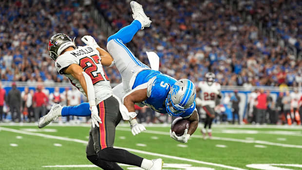 Detroit Lions running back David Montgomery jumps over Tampa Bay Buccaneers cornerback Zyon McCollum