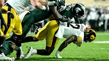 Michigan State's Malik Spencer, top, tackles Iowa's Kaleb Johnson in the second quarter on Saturday, Oct. 19, 2024, at Spartan Stadium in East Lansing.