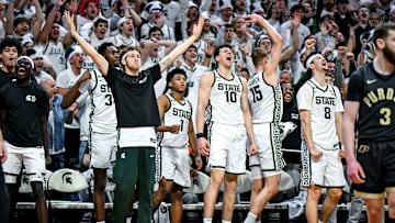 Michigan State's bench celebrates after Coen Carr's dunk against Purdue during the second half on Tuesday, Feb. 18, 2025, at the Breslin Center in East Lansing.