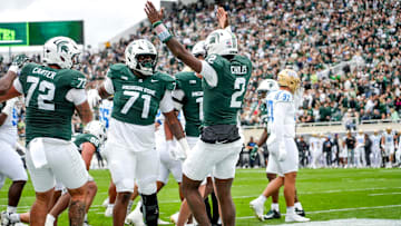 Michigan State's Aidan Chiles, center, celebrates his touchdown against UCLA during the first quarter on Saturday, Oct. 11, 2025, at Spartan Stadium in East Lansing.