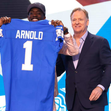 Terrion Arnold, a cornerback from the University of Alabama, shows off his Detroit Lions jersey with