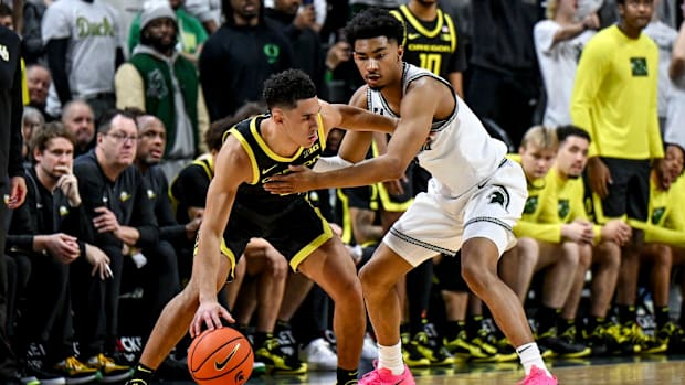 Michigan State's Jaden Akins, right, guards Oregon's Jackson Shelstad during the second half on Saturday, Feb. 8, 2025, at th